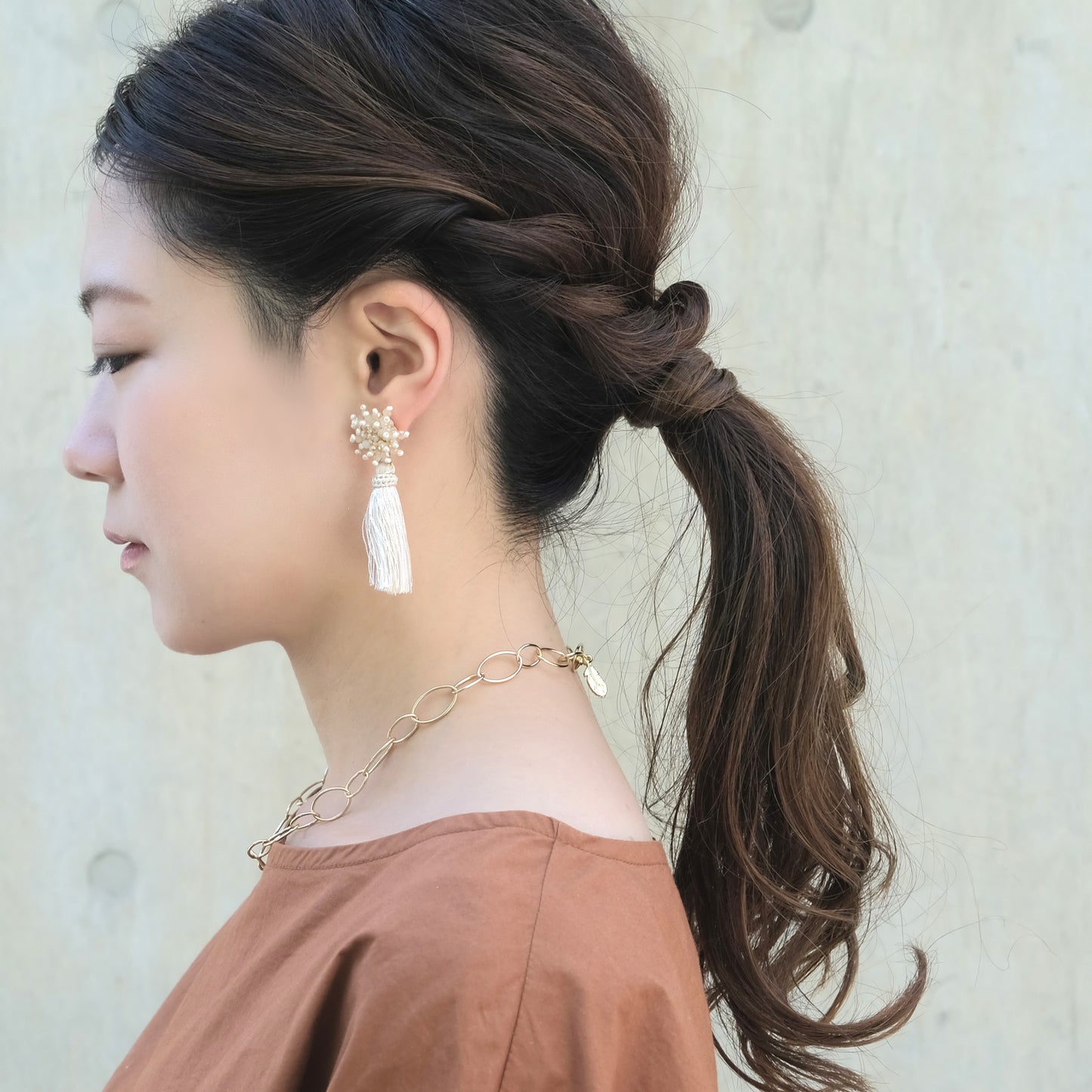 Bead motif x tassel earrings